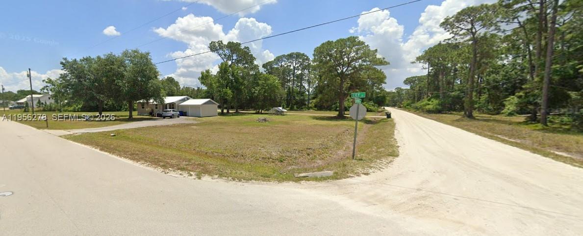 A vacant, grassy corner lot sits at the intersection of two unpaved roads — 6203 BANYAN RD, Sebring FL 33875, SEBRING, FL