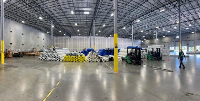 A large, open warehouse interior features concrete floors, high ceilings, and stacked rolls of material — 3501 SW 46th Ave, Davie FL 33314, DAVIE, FL