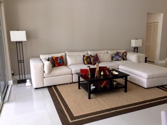 A living room features a white sectional sofa, a black coffee table, and a floor lamp — 5463 NW 20th Avenue, Boca Raton FL 33496, BOCA RATON, FL