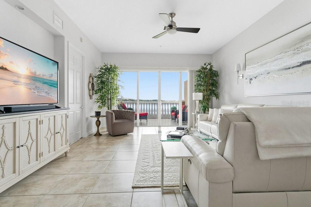 A dining room features a wooden table, upholstered chairs, a pendant light, and wall art — 8755 THE ESPLANADE UNIT 104, ORLANDO, FL