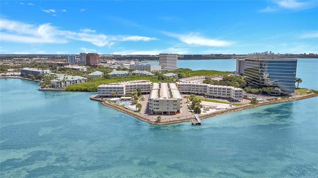 An aerial view shows a multi-story residential complex situated on a point of land — 2506 N ROCKY POINT DRIVE UNIT 331 and #275, TAMPA, FL