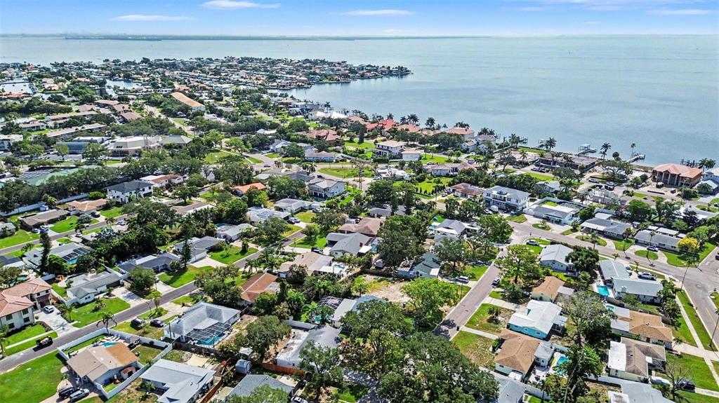An aerial view of a residential neighborhood situated along a large body of water — 1737 COLORADO AVENUE NE, ST PETERSBURG, FL