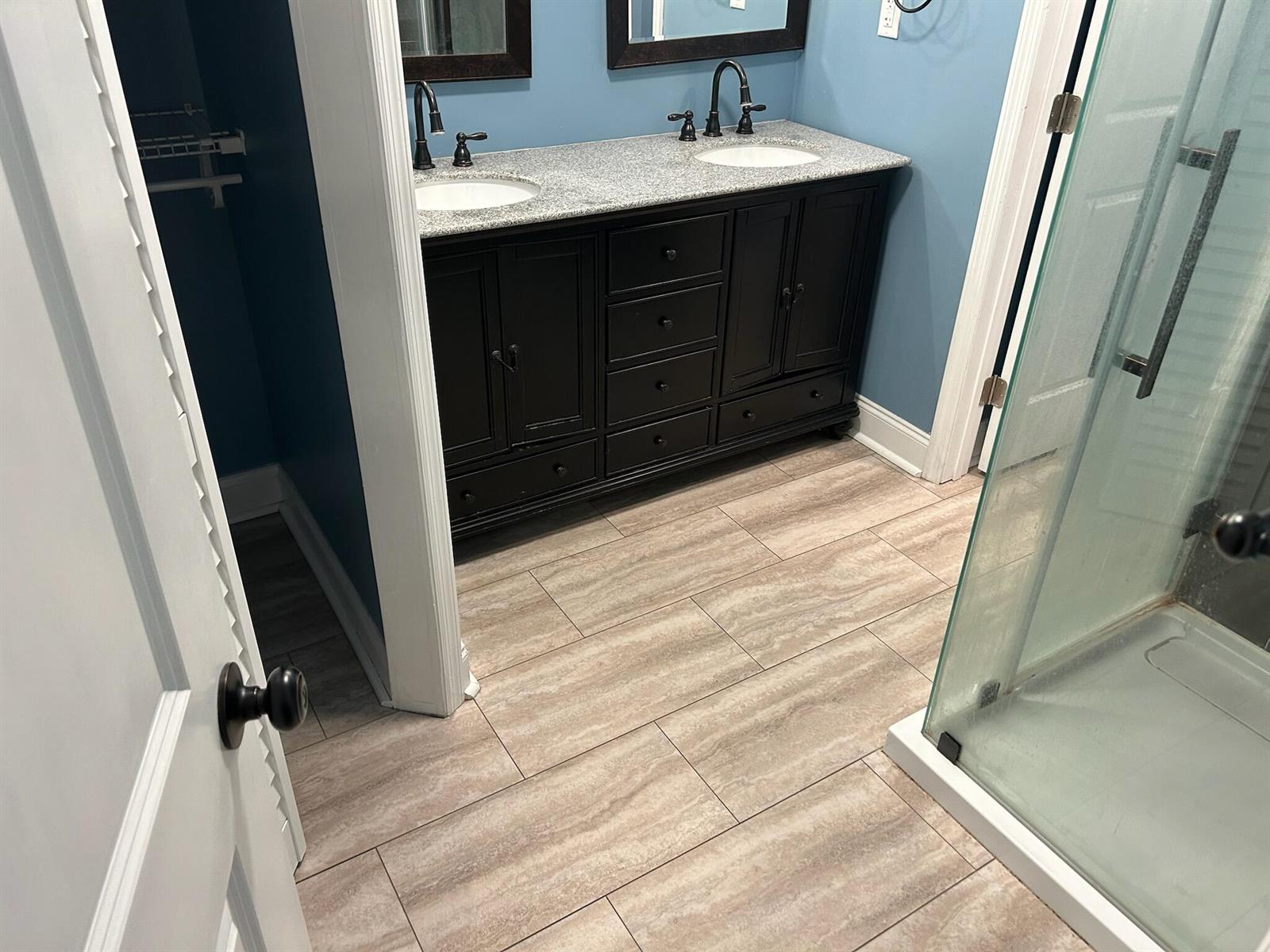 A bathroom features a double vanity with a granite countertop, dark cabinets, and tiled flooring — 6120 9th Avenue S, FL 33707, FL