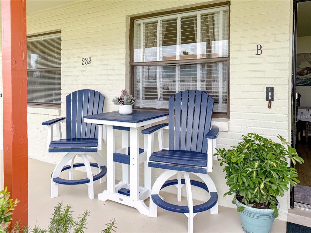 A patio features two blue and white swivel chairs and a matching table — 232 NORTHSHORE DRIVE UNIT A & #B, ORMOND BEACH, FL