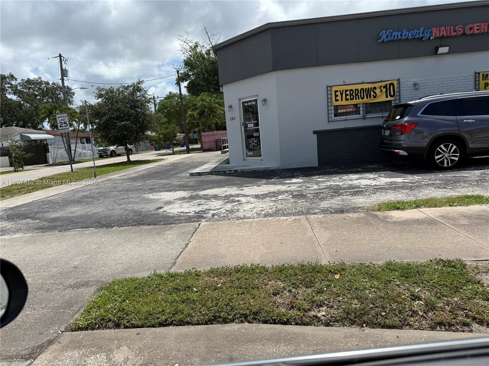 A gray commercial building with a parking lot and an eyebrow service sign — 1953 SW 27th Ave, Miami FL 33145, MIAMI, FL