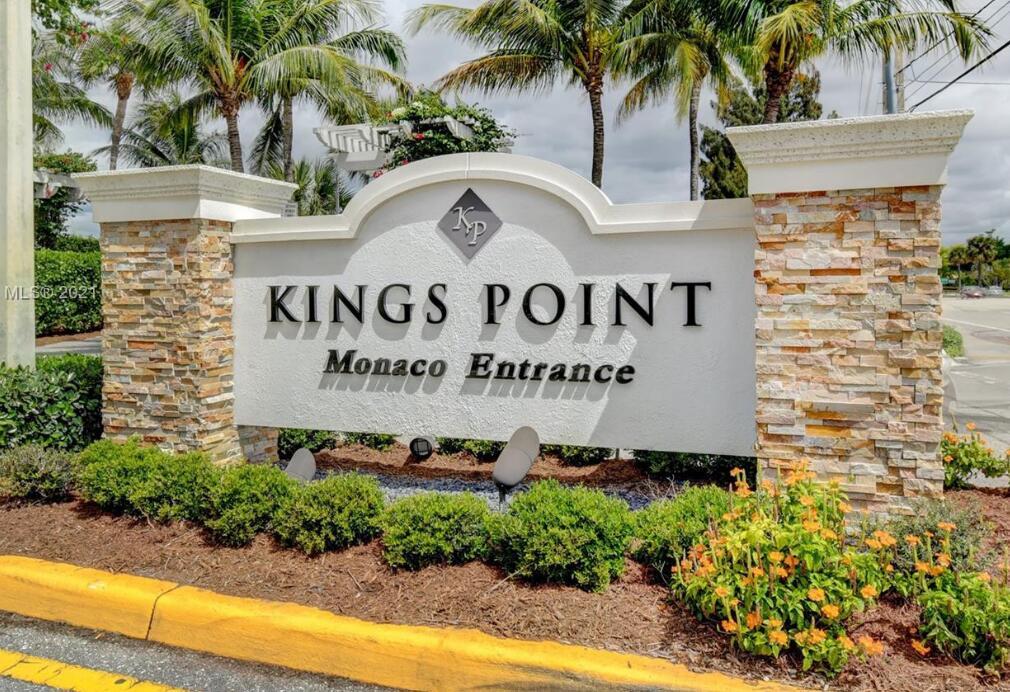 A stone-accented monument sign marks the Monaco entrance to the Kings Point community — 193 Saxony E, Delray Beach FL 33446, DELRAY BEACH, FL