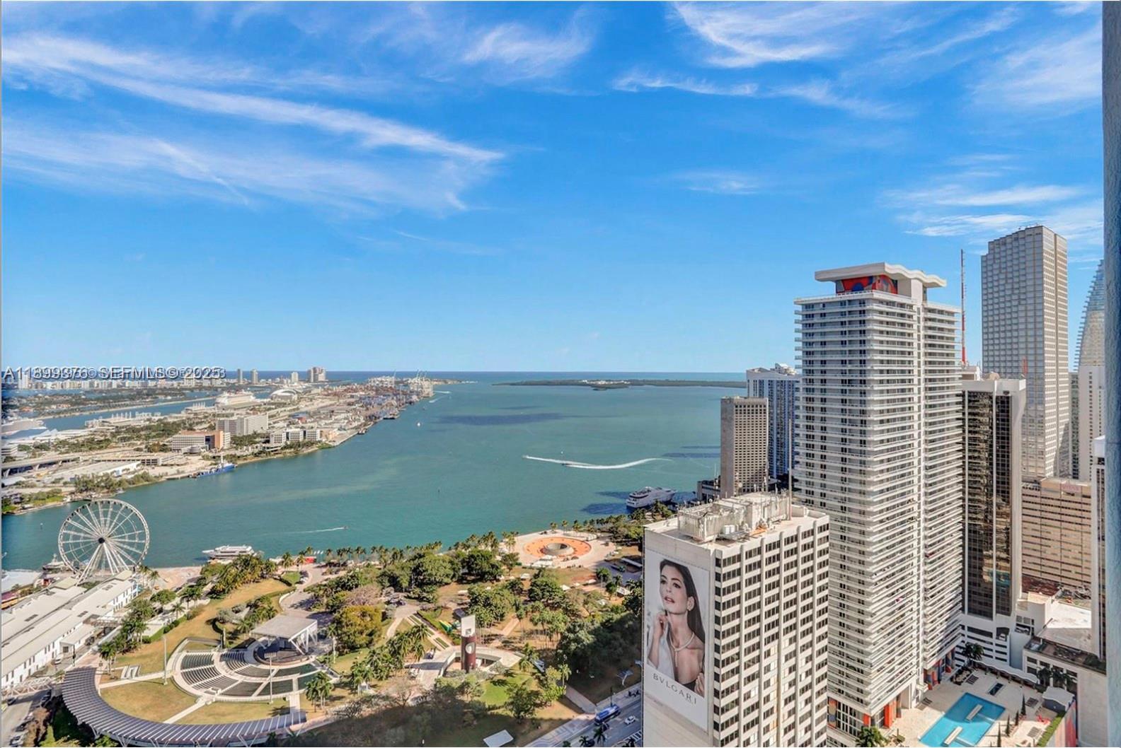 An elevated view shows a city park, a large Ferris wheel, and skyscrapers overlooking a bay — 253 NE 2nd St # 226, Miami FL 33132, MIAMI, FL