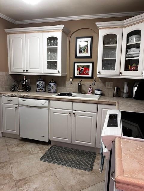 A kitchen features white cabinets, a tiled countertop, and a dishwasher under an arched wall — 1500 S Ocean Dr # 9J, Hollywood FL 33019, HOLLYWOOD, FL