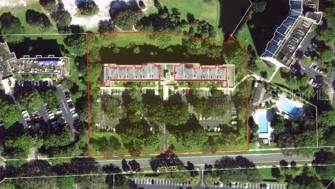 This aerial map shows a multi-unit residential building surrounded by parking lots and green space — 3503 OAKS WAY UNIT 212, POMPANO BEACH, FL