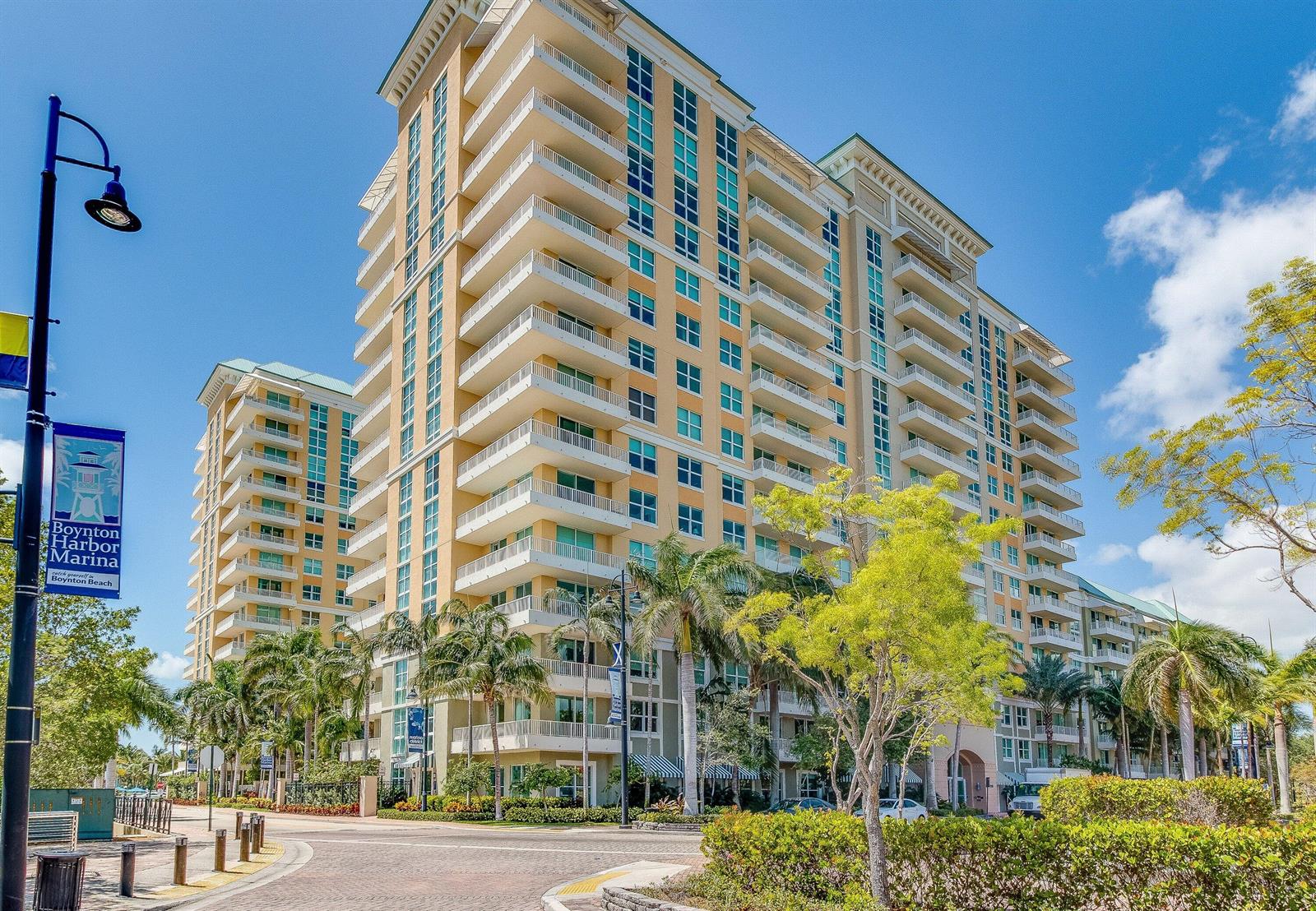 A tall, multi-story apartment building with balconies stands near a street with palm trees — 700 E Boynton Beach Boulevard # 803, Boynton Beach FL 33435, BOYNTON BEACH, FL