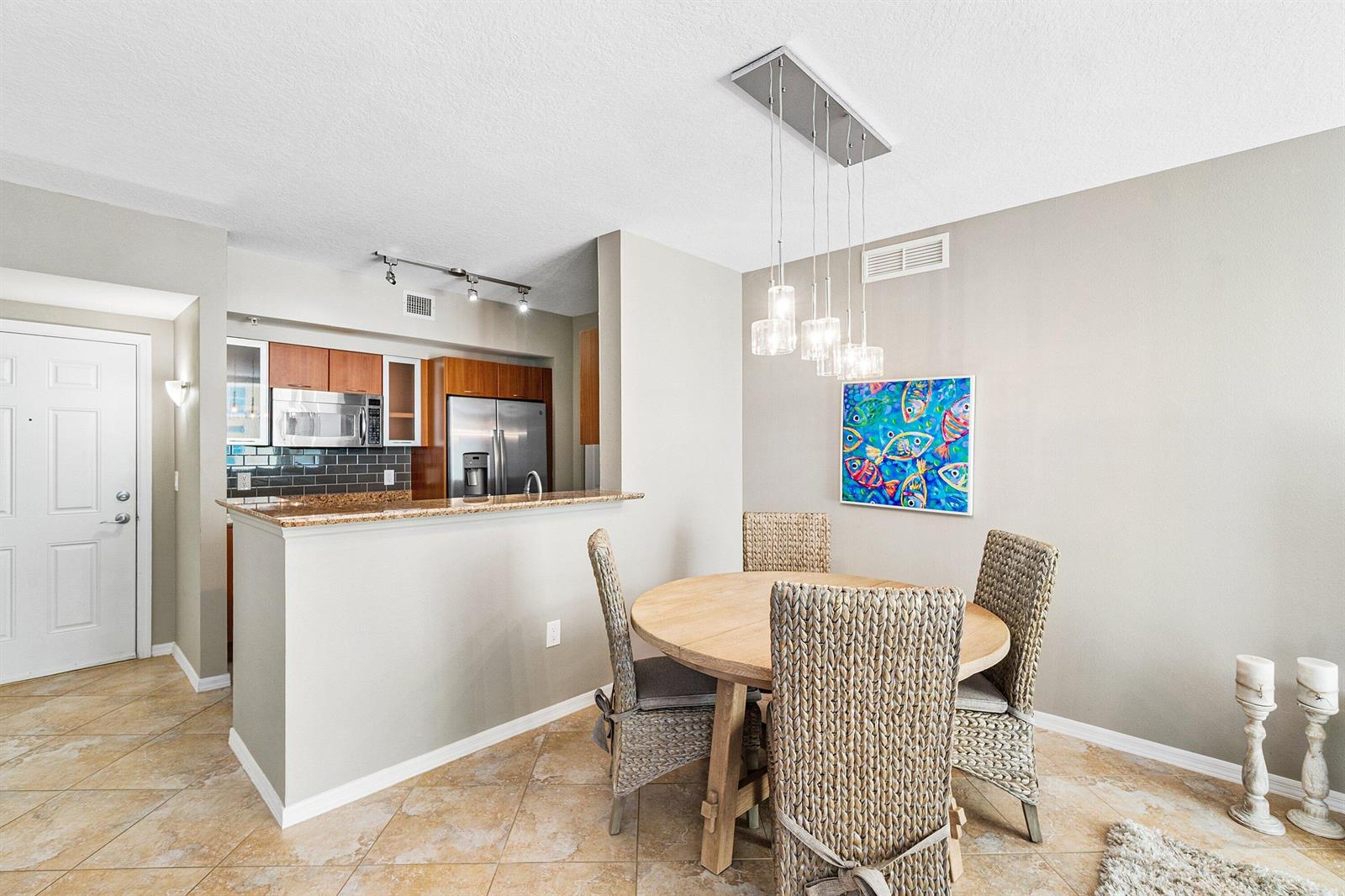 A view through an open doorway into a condo unit with tiled floors and furniture — 700 E Boynton Beach Boulevard # 803, Boynton Beach FL 33435, BOYNTON BEACH, FL