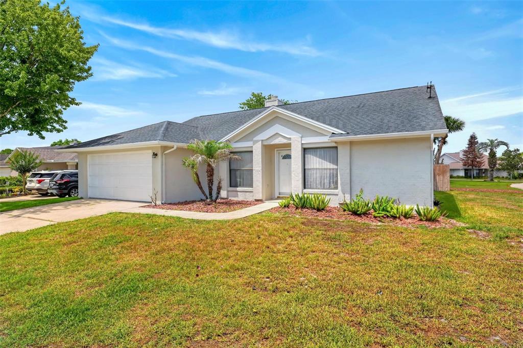 A single-story house with a white stucco exterior, a two-car garage, and a front lawn — 759 TOMLINSON TERRACE, LAKE MARY, FL