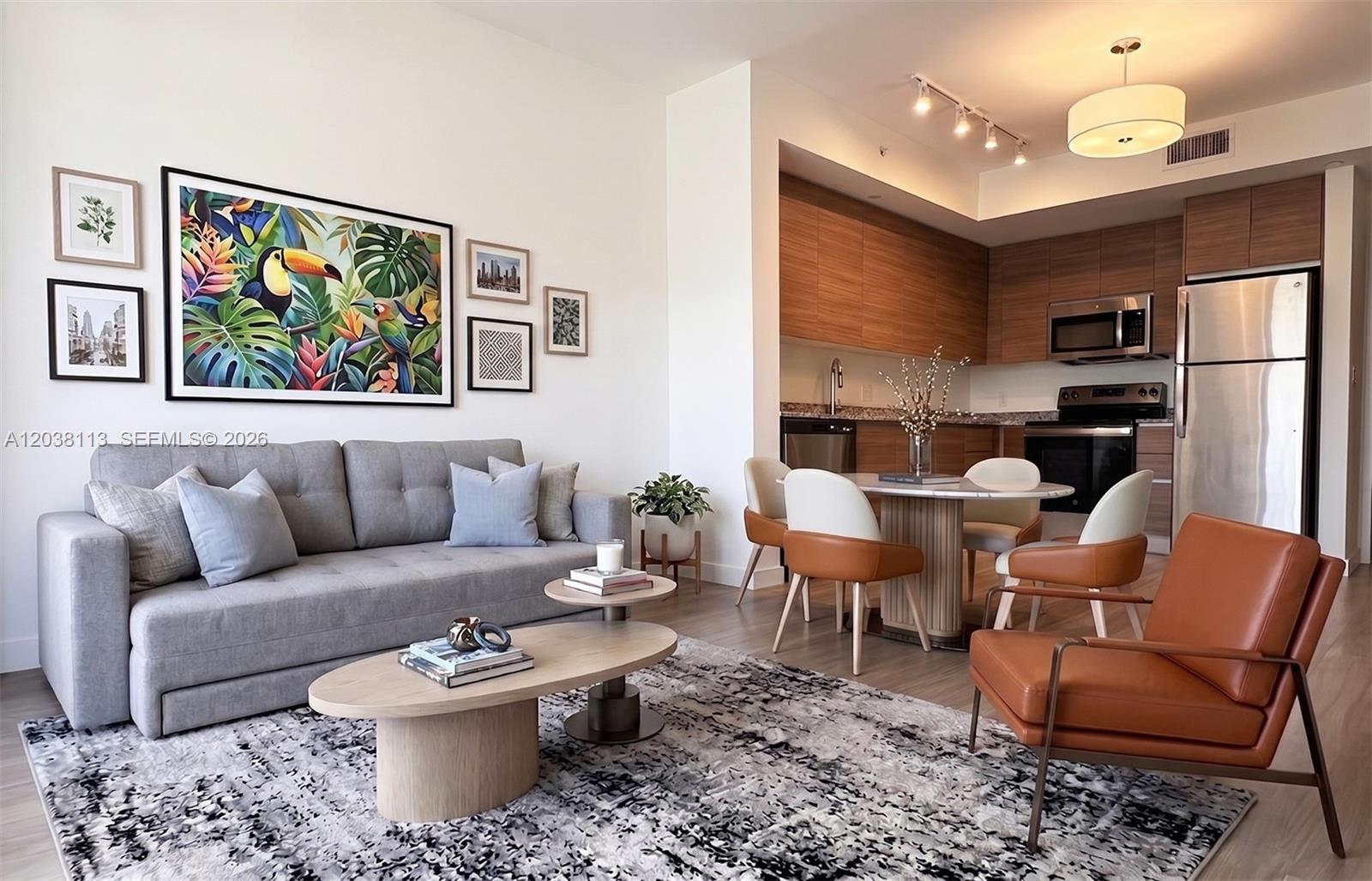 A living room and kitchen area feature a gray sofa, wood coffee tables, and dining set — 315 NW 27th Ave # 303, Miami FL 33125, MIAMI, FL