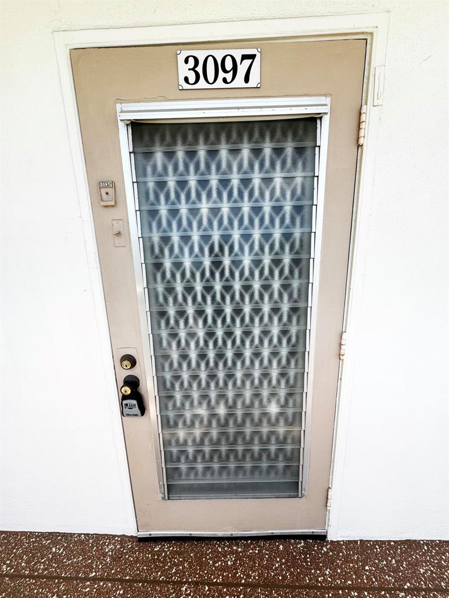 A tan exterior door with a louvered glass insert and a lockbox — 3097 Newport S # 3097, Deerfield Beach FL 33442, DEERFIELD BEACH, FL