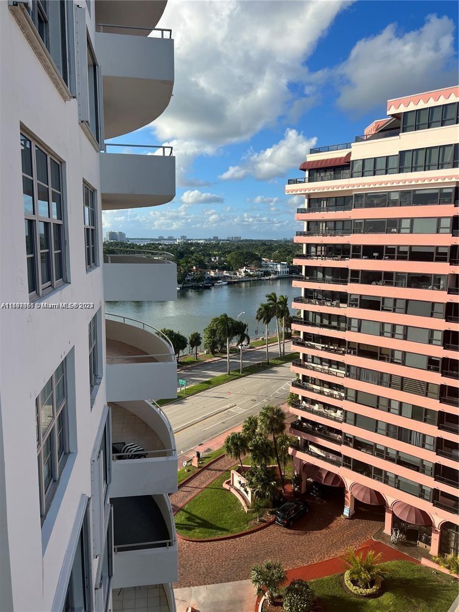 An elevated view shows a street and waterway between two high-rise apartment buildings — 5161 COLLINS AVE # 1403, Miami Beach FL 33140, MIAMI BEACH, FL