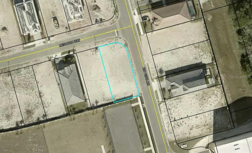 This is an aerial map showing a vacant corner lot outlined in blue — 2 MENORCA WAY, PALM COAST, FL