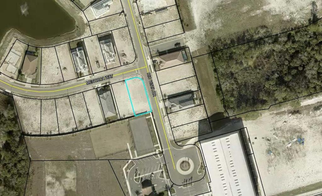 This is an aerial map showing a vacant residential lot outlined in blue at a street corner — 2 MENORCA WAY, PALM COAST, FL