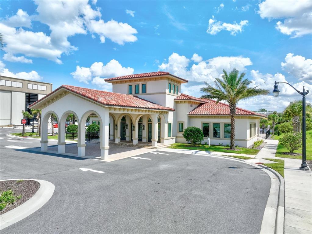 A Mediterranean-style building with a tiled roof and a covered arched entryway under a sky — 2 MENORCA WAY, PALM COAST, FL