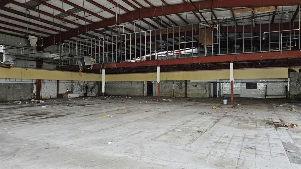 An empty, dilapidated commercial warehouse space with exposed metal framing and a concrete floor — 97 SATURNINO RODRIGUEZ #97, YABUCOA, PR