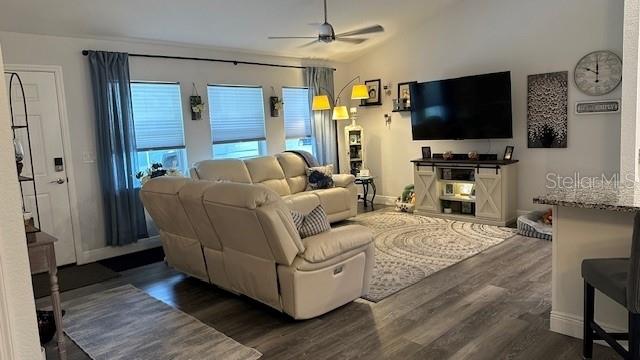 A living room features light-colored reclining sofas, a television console, and wood-look flooring — 1113 PORSCHE AVENUE, SEBRING, FL
