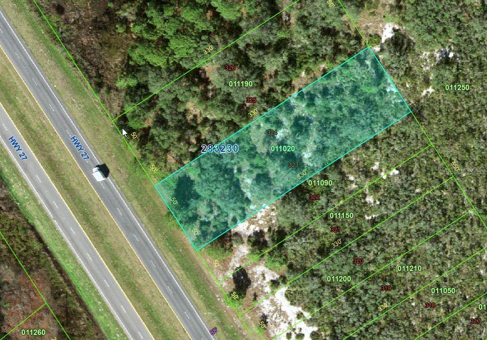 This is an aerial map showing a highlighted rectangular parcel of land adjacent to a highway — US HIGHWAY 27, FROSTPROOF, FL