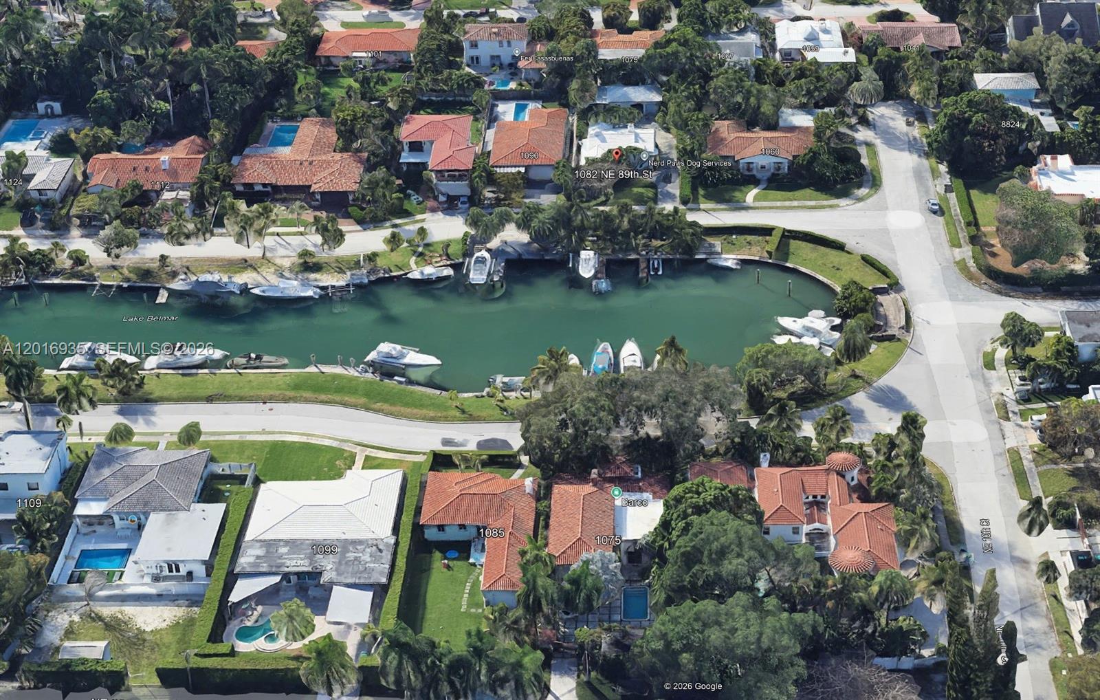 An aerial view shows waterfront homes with pools and boat docks along a curved canal — 1082 NE 89th St, Miami FL 33138, MIAMI, FL