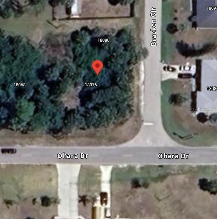 This is an aerial map showing a vacant, wooded corner lot at a street intersection — 18076 OHARA DRIVE, PORT CHARLOTTE, FL