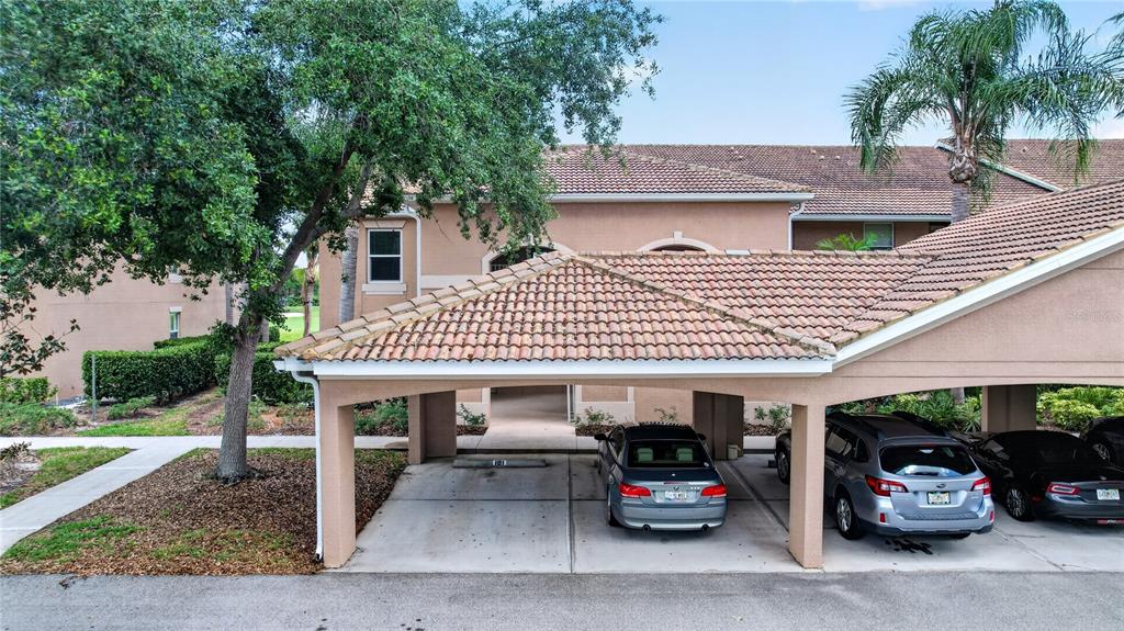 The exterior view shows a beige building entrance with a door labeled 101 and a patio — 915 FAIRWAYCOVE LANE UNIT 101, BRADENTON, FL