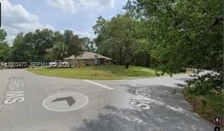 A single-story house sits at the end of a residential street surrounded by trees — 0 SW SW 97 PL, Dunnellon, Ocala FL 34432, OCALA, FL