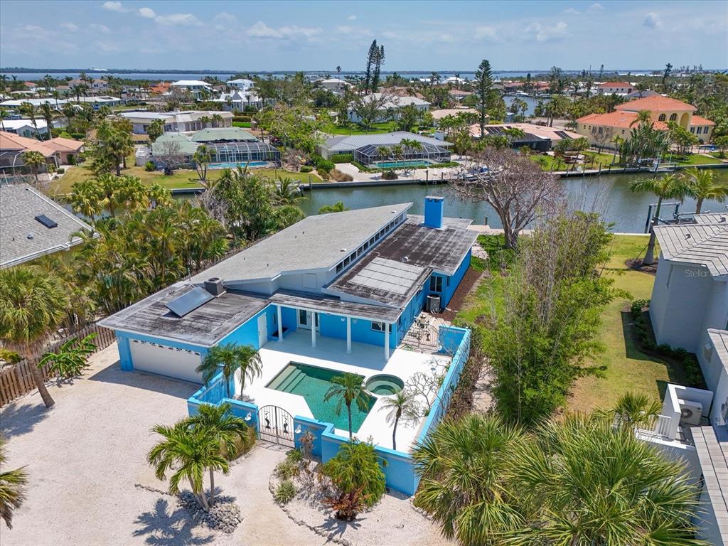 An aerial view of a bright blue house with a private pool and canal access — 5920 GULF OF MEXICO DRIVE, LONGBOAT KEY, FL