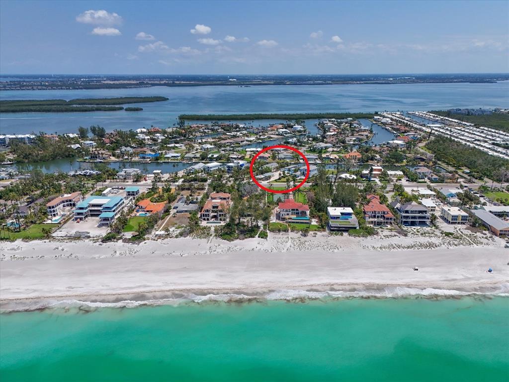 An aerial view of a coastal beach neighborhood with a red circle highlighting specific properties — 5920 GULF OF MEXICO DRIVE, LONGBOAT KEY, FL