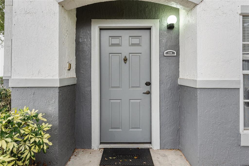 A gray front door with a door knocker and number plate sits in a recessed entryway — 4356 S KIRKMAN ROAD UNIT 514, ORLANDO, FL