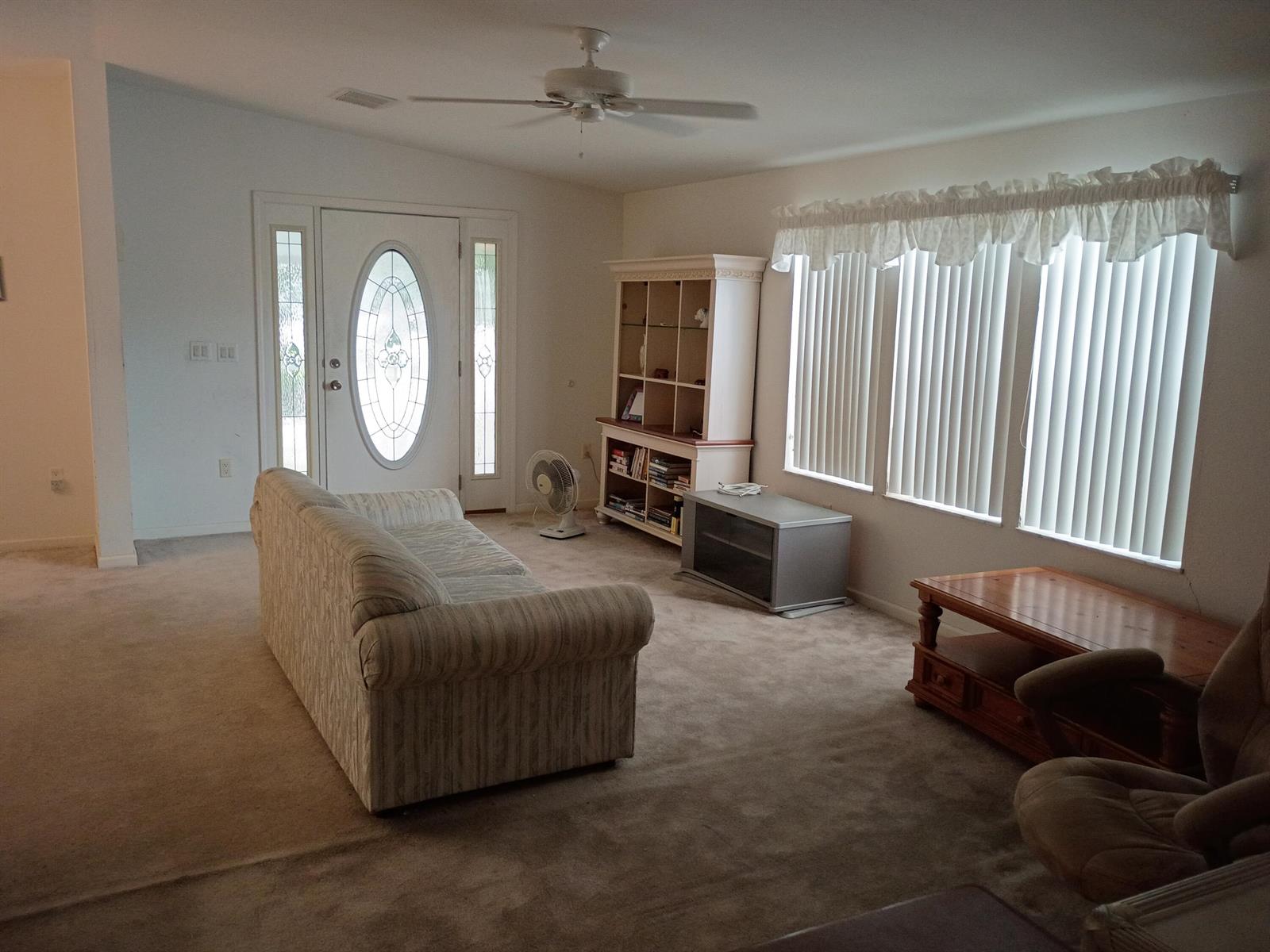 A living room features beige carpet, a white sofa, a hutch, and large windows with blinds — 2080 SW 85th Avenue, Davie FL 33324, DAVIE, FL