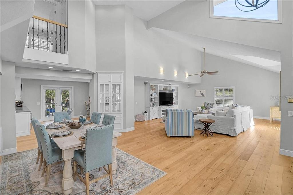 A two-story white house with a prominent arched entryway and a concrete driveway — 320 RINGLING POINT DRIVE, SARASOTA, FL