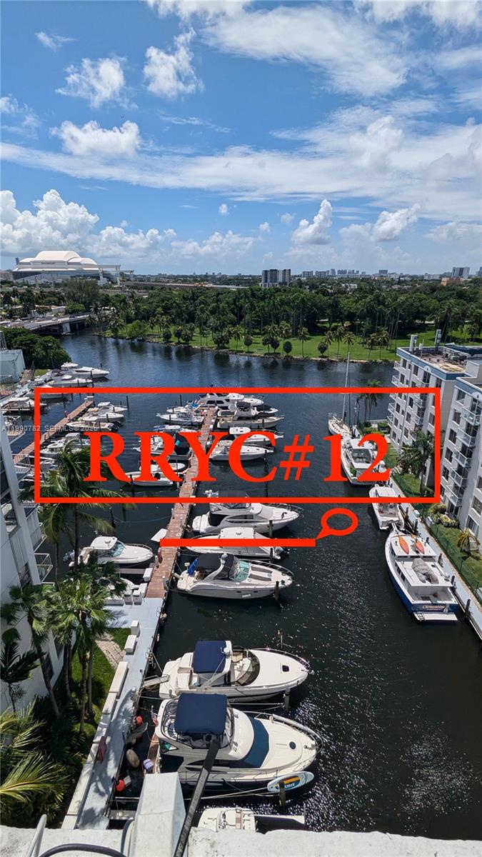 An elevated view shows a marina with multiple docked boats along a narrow canal — 1700 NW North River Dr, Miami FL 33125, MIAMI, FL