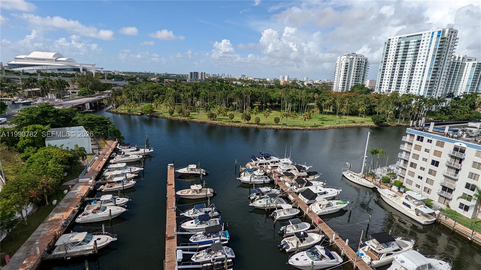 An elevated view of a marina with numerous boats docked along piers near a park — 1700 NW North River Dr, Miami FL 33125, MIAMI, FL