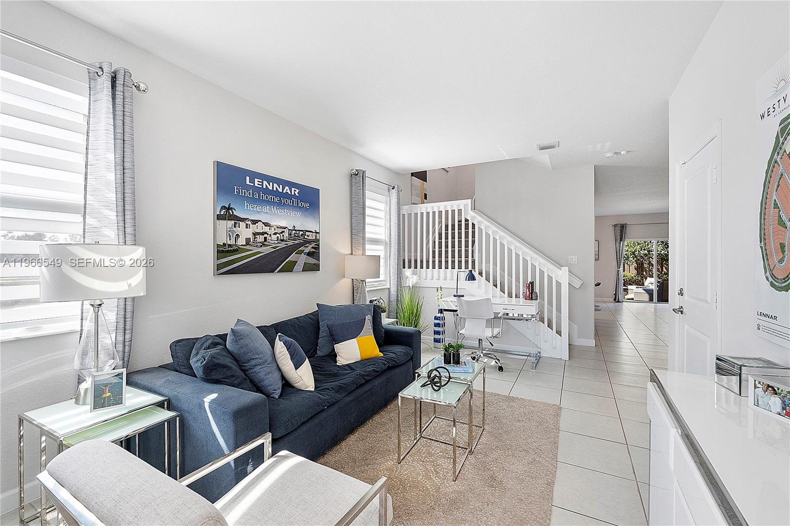 A living room features a blue sofa, a glass coffee table, and a staircase — 2361 NW 125th St, Miami FL 33167, MIAMI, FL