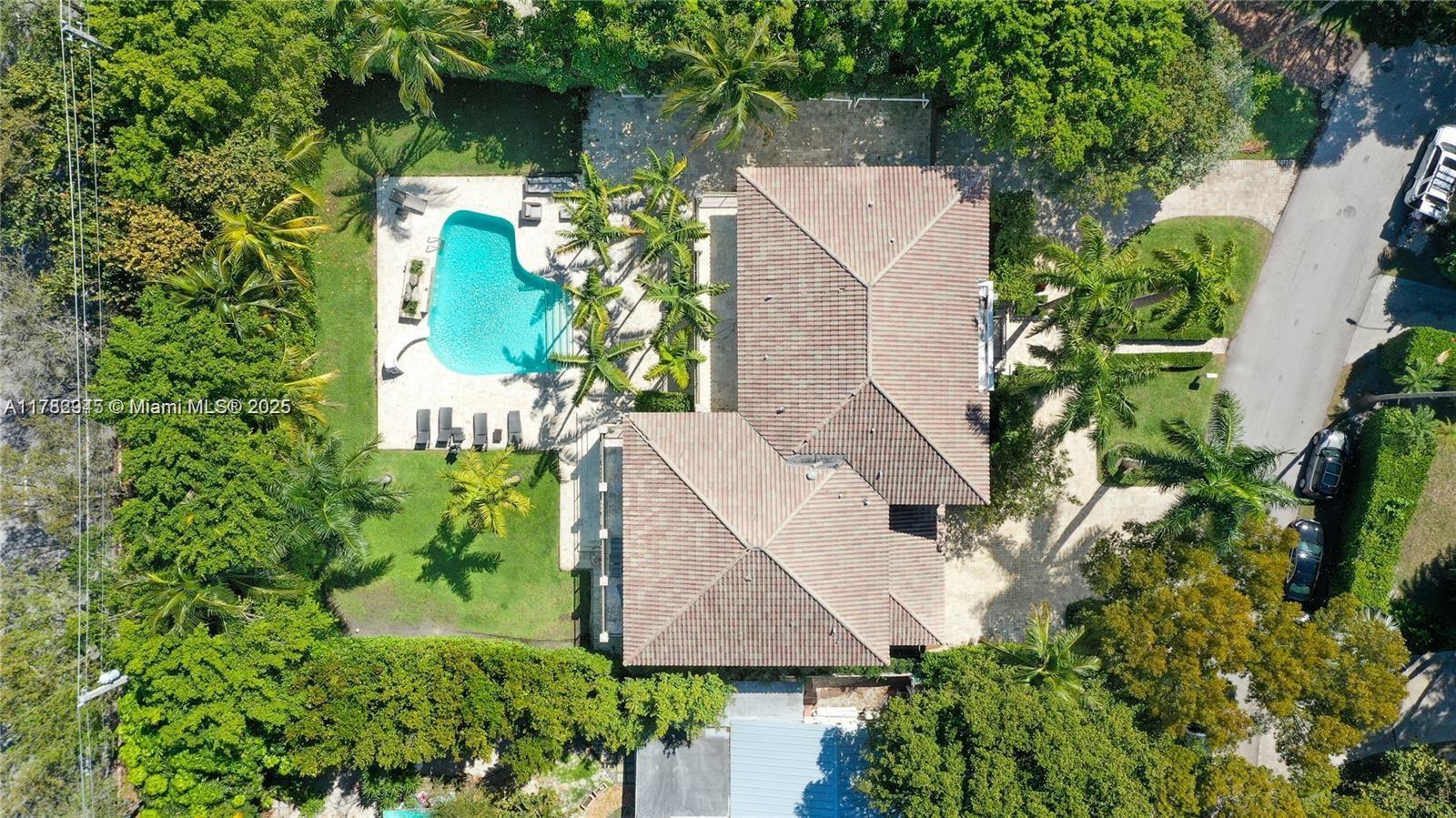 An aerial view shows a house with a tiled roof, a swimming pool, and landscaping — 31 Island Dr, Key Biscayne FL 33149, KEY BISCAYNE, FL