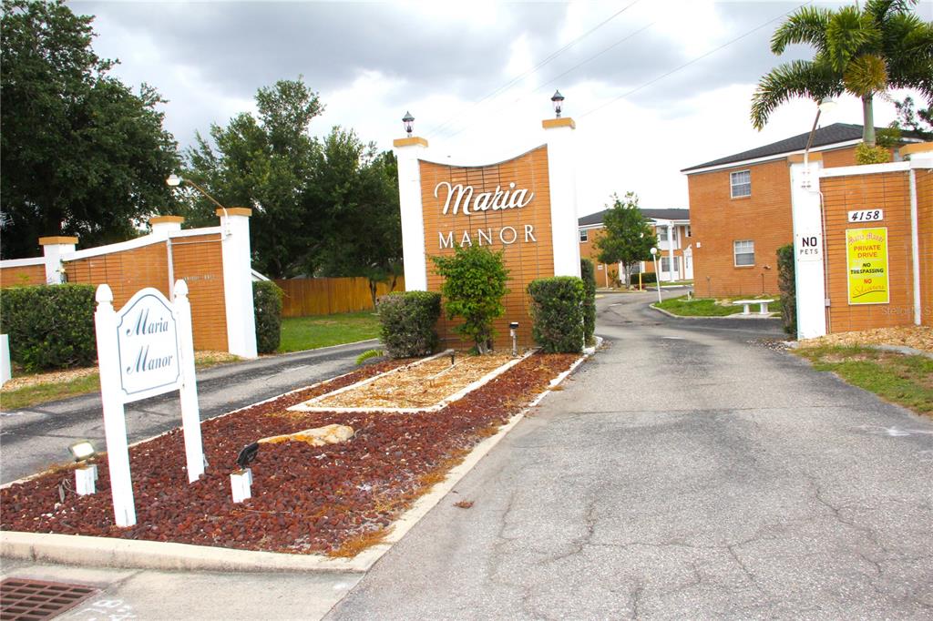 The entrance to the Maria Manor apartment complex features a brick sign and driveway — 4158 TAMIAMI TRAIL UNIT B6, PORT CHARLOTTE, FL