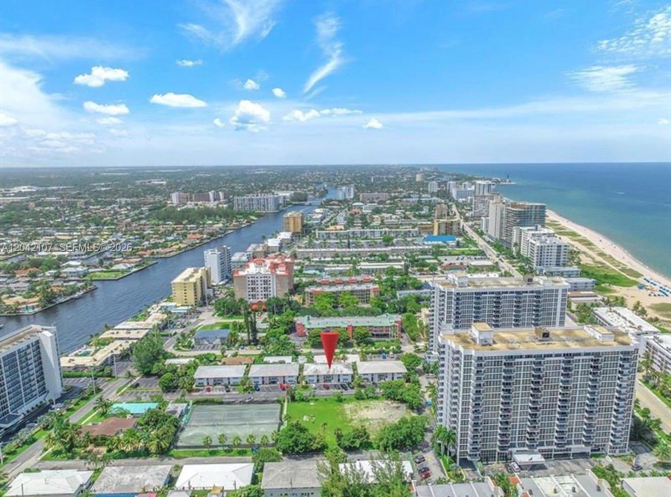 An aerial view shows a low-rise residential building marked with a red pin near water — 3213 Colony Club Rd, Pompano Beach FL 33062, POMPANO BEACH, FL