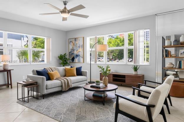 A living room features a gray sofa, two armchairs, a coffee table, and large windows — 3213 Colony Club Rd, Pompano Beach FL 33062, POMPANO BEACH, FL