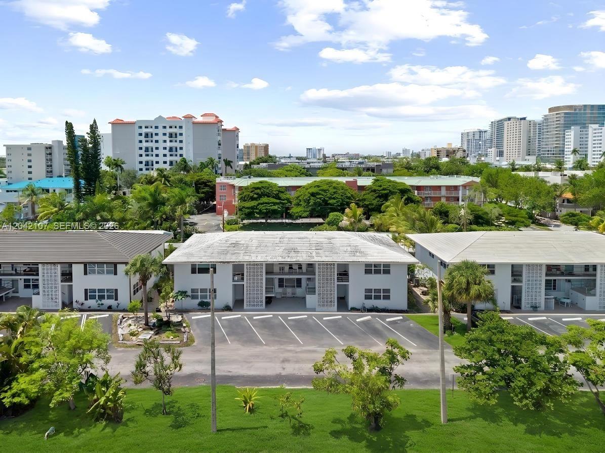 An aerial view shows three low-rise apartment buildings with parking lots and surrounding green landscaping — 3213 Colony Club Rd, Pompano Beach FL 33062, POMPANO BEACH, FL