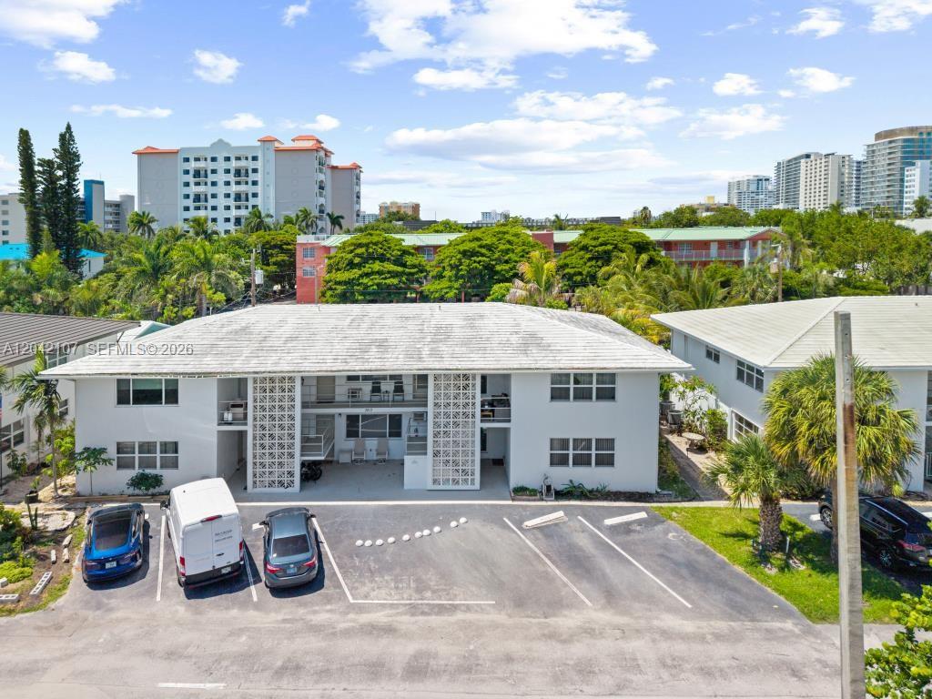 An aerial view shows a two-story white apartment building with a parking lot in front — 3213 Colony Club Rd, Pompano Beach FL 33062, POMPANO BEACH, FL