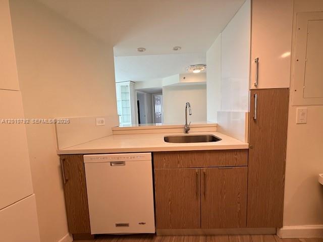 A kitchen features a stainless steel sink, a white dishwasher, and light wood cabinetry — 2415 NW 16th St Rd # 1, Miami FL 33125, MIAMI, FL