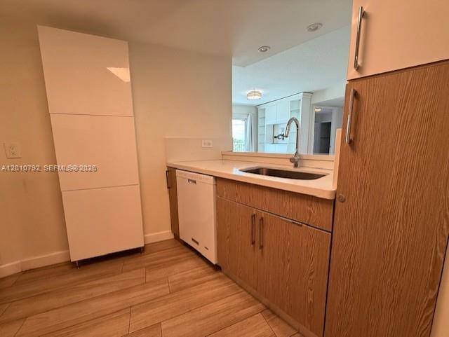 A kitchen features light wood cabinets, a white dishwasher, and a stainless steel sink — 2415 NW 16th St Rd # 1, Miami FL 33125, MIAMI, FL