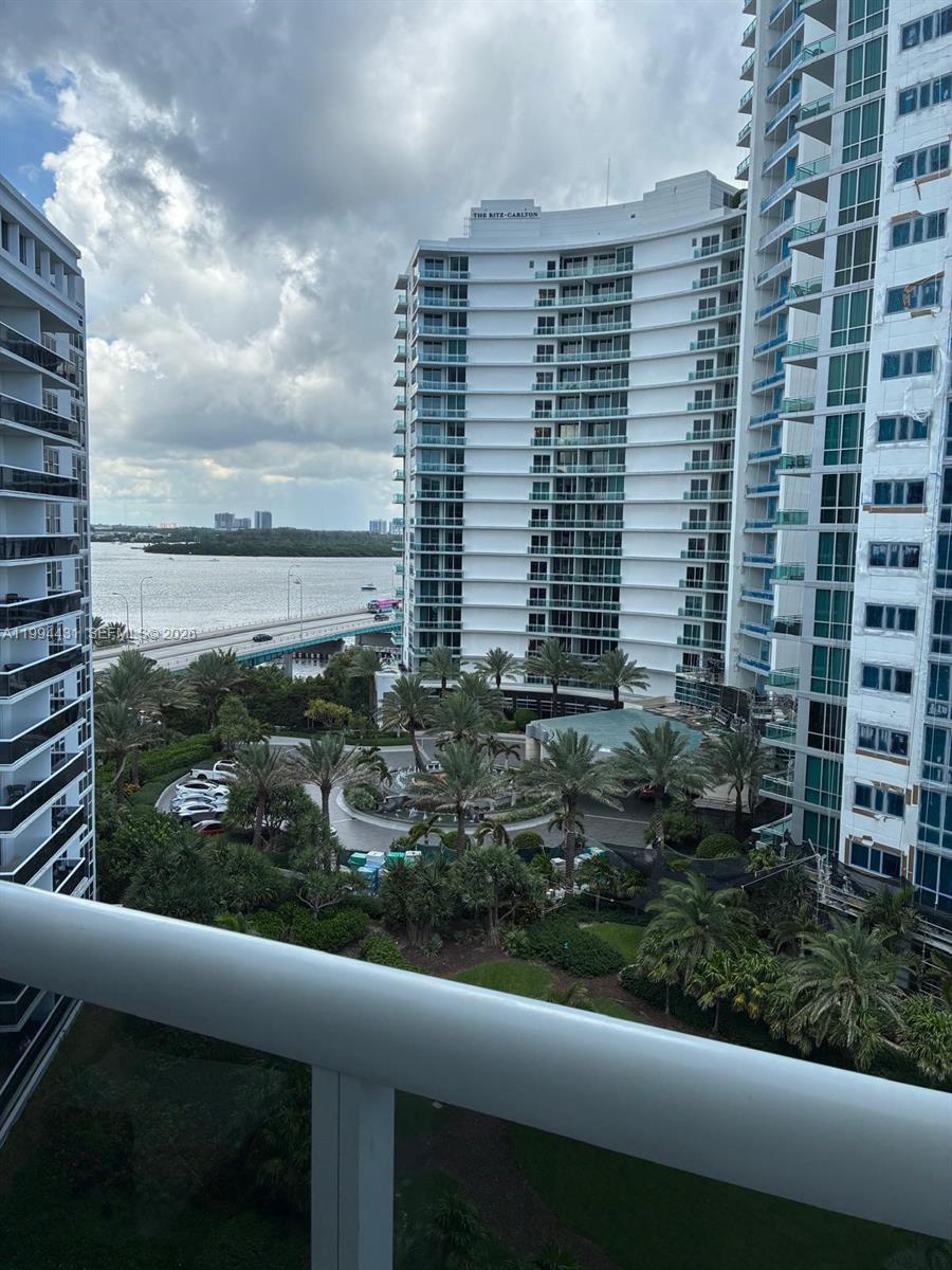 An elevated view shows a courtyard with palm trees between two tall residential buildings — 10275 Collins Ave # 1004, Bal Harbour FL 33154, BAL HARBOUR, FL