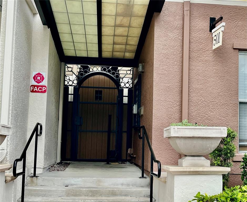 A swimming pool and hot tub are surrounded by palm trees and a wooden bench — 501 S MOODY AVENUE UNIT 1119B, TAMPA, FL