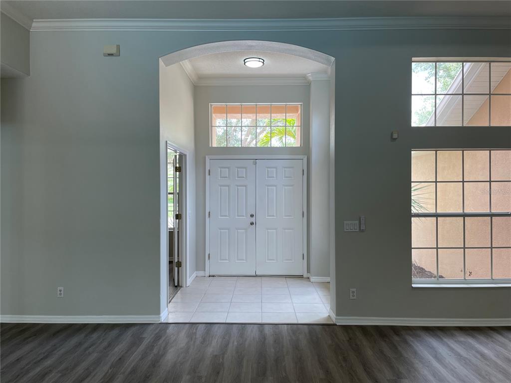 An entryway with a tiled floor, double front doors, and an arched ceiling — 6119 PALOMINO CIRCLE, BRADENTON, FL