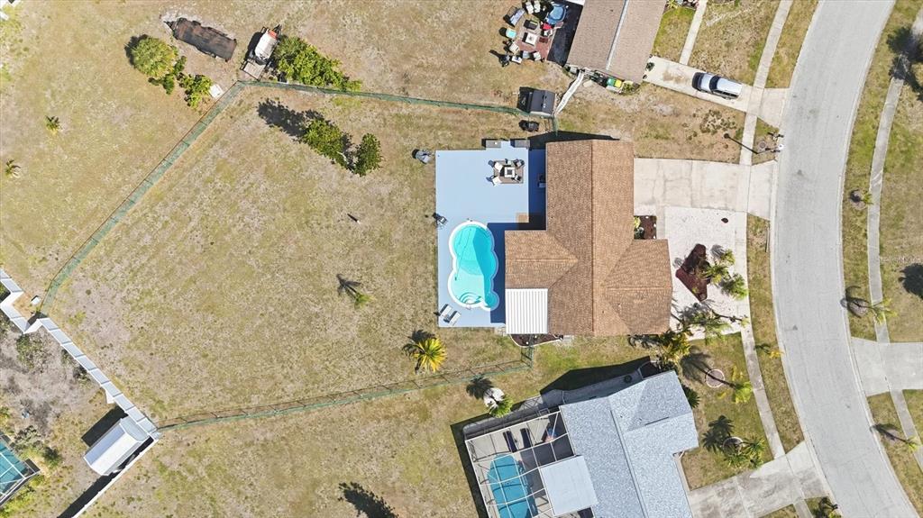 An aerial view shows a house with a pool and patio on a large lot — 6358 GRANGER ROAD, PORT CHARLOTTE, FL