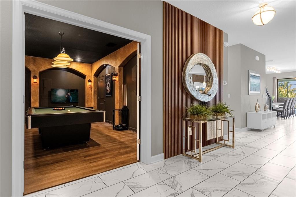 A view from a tiled hallway into a game room featuring a pool table — 2931 FABLE STREET, KISSIMMEE, FL